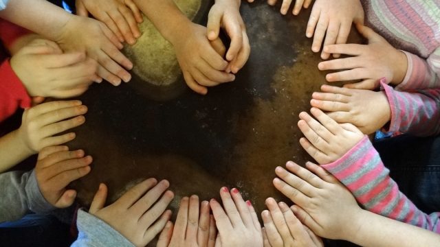 Childrens hands arranged in a heart formation