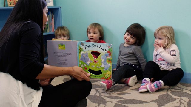 A teacher reading a copy of 