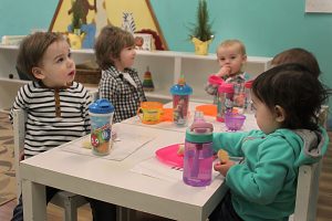 Toddlers having snacks together