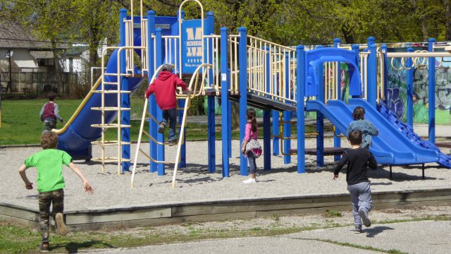 A group of children running to play on a playground