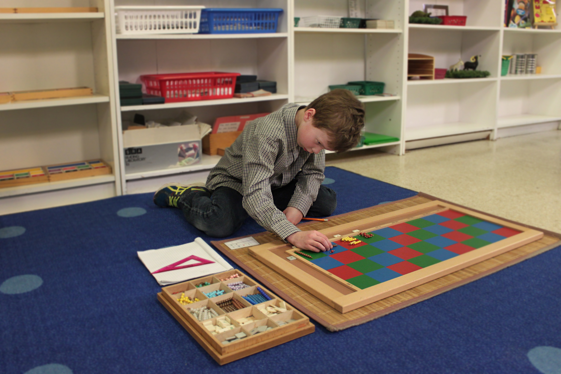Little boy playing with educational toys on the floor